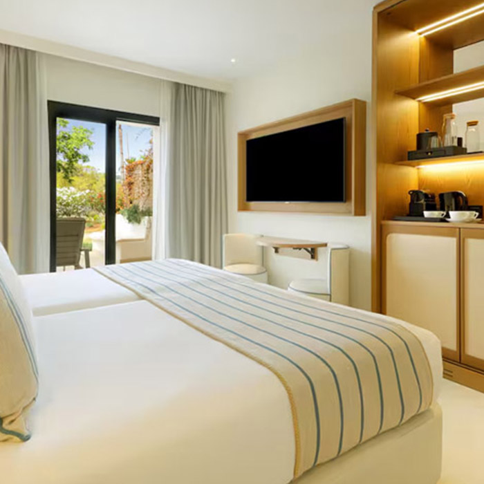 standard room with beige and blue decor and terrace at trs ibiza
